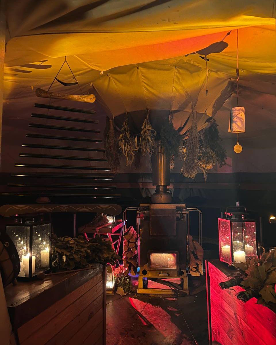 The wood-fired stove inside the banya, lit with candles